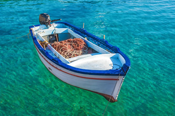 wooden fishing boat in blue water
