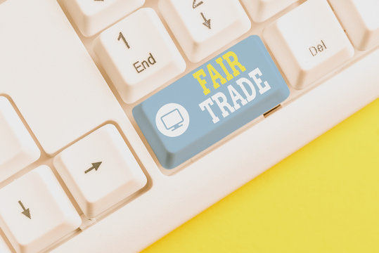 Text sign showing Fair Trade. Business photo showcasing Small increase by a analysisufacturer what they paid to a producer White pc keyboard with empty note paper above white background key copy space