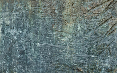 A grunge background made of the sorbed surface of the old stone. Bulges and scratches