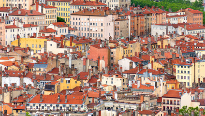 Fototapeta na wymiar Red roofs and stone chimneys are the traditional architecture of the historic center of the french city of Lyon as well as many old European towns