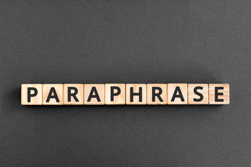 Obraz premium paraphrase - word from wooden blocks with letters, rewrite retelling using other paraphrase words concept, top view on grey background