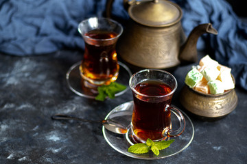 Arabic, oriental tea with lemon. Warms on cold evenings, cools in the hot summer. Heals colds. Nearby lies a fresh root and lime green.