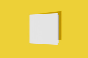 Mockup square booklet, brochure, invitation isolated on a yellow background with hard cover and realistic shadow. 3D rendering.
