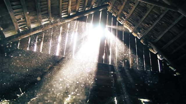 Dust flies in the rays of sunlight in the attic of the old barn HD 1920x1080