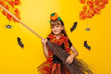 Child in witch costume playing broomstick guitar