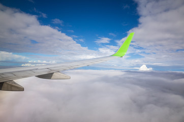 Fototapeta na wymiar View from airplane window over cloud sky