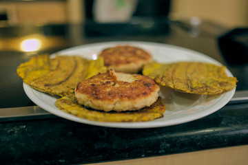 fried plantain burgers made with chicken patties and using fried plantains as buns. traditional all over the caribbean