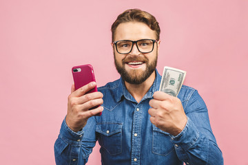 Happy winner! Bearded happy man demonstrating his money prize and using smartphone isolated over...