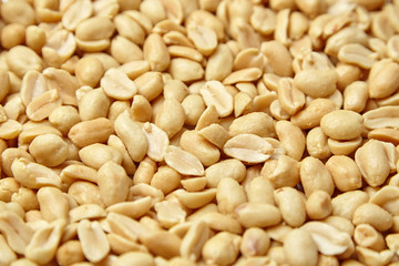 roasted peeled peanuts, salted snack as background. high calorie product