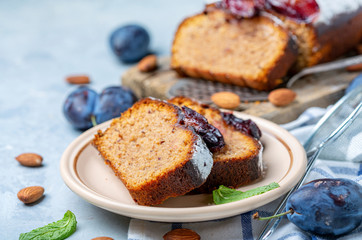 Slices of traditional plum cake on ceramic plate.