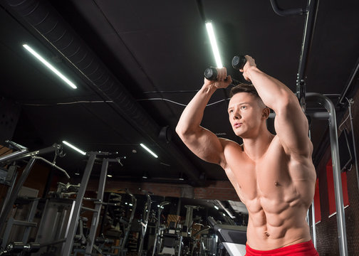 Premium Photo  Shirtless man doing tricep curls with dumbbells in
