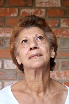 Portrait of an older mixed race woman looking up with stunning brown eyes