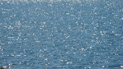 Wasseroberfläche See mit kleinen glitzernden Wellen