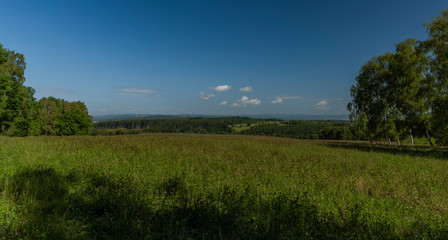 Meadows over Stedra village in Slavkovsky les national park in summer day