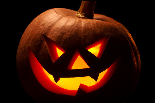 Halloween pumpkin with scary face. Jack-o-lantern in the dark