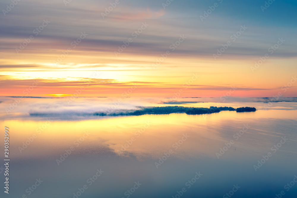 Wall mural Long Exposure of Sunrise at the Paijanne lake. Beautiful scape with sunrise sky,fog, pine forest and water. Lake Paijanne, Finland. - Wall murals