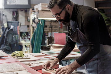 Guitar luthier working in his workshop