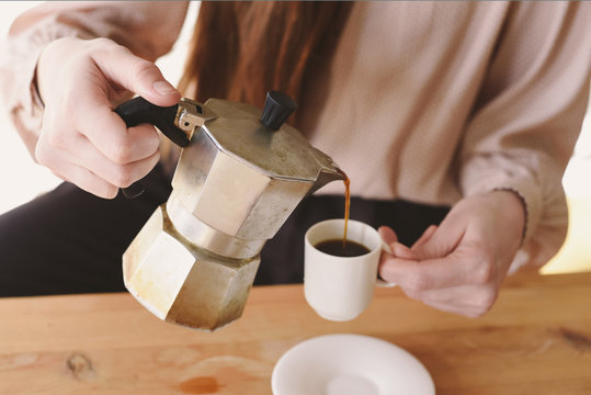 Woman pours coffee