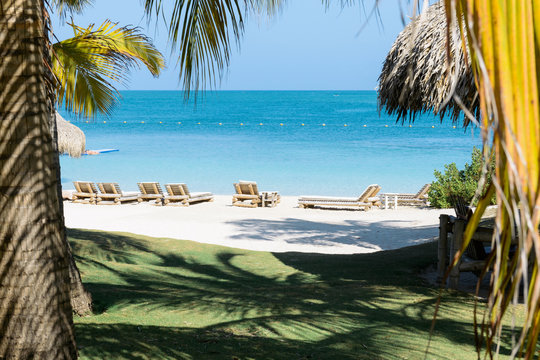 Empty beach chairs await vacationers on Isla Mucura