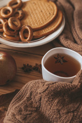 Autumnal mood. Sweet cookies and apples. Drinking hot tea in cold autumn days. Cold weekend at home.