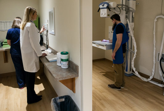 Clinic: Doctor Pushing Button For X-ray Machine