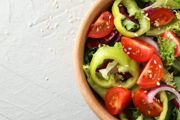 Fresh salad with sesame on grey background, close up