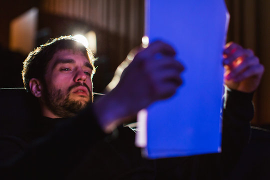 Actor reviewing script sitting in theatre.