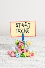 Writing note showing Start Doing. Business concept for asking someone to go with action right now dont hesitate Reminder pile colored crumpled paper clothespin wooden space