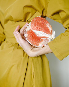 Crop woman with half of peeled pomelo
