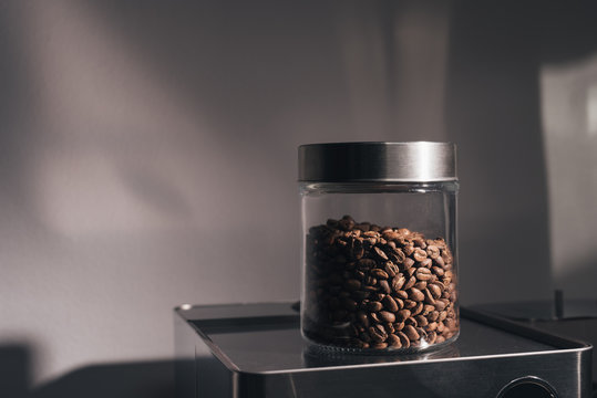 Fresh whole coffee beans in a glass  jar