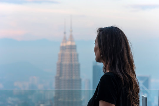 Woman looking the skyline of Kuala Lumpur, Malaysia