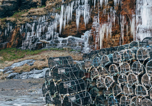 Icicles and lobster pots in the harbour at Boscastle. Cornwall, UK.