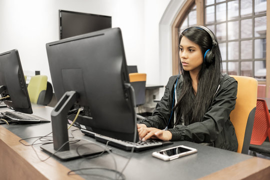 Asian College Student Working On A Computer In School