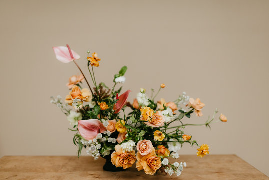 Florist in studio building a stunning floral arrangement