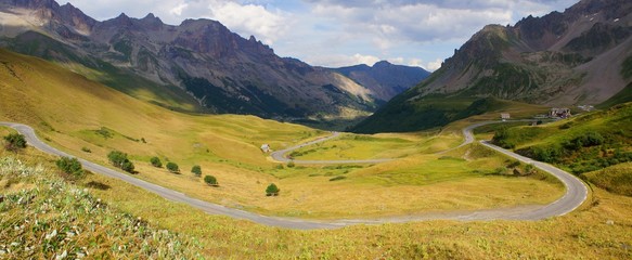 Winding road in the Guisane valley shot from the Galibier pass in french Alps, on the road of tour...