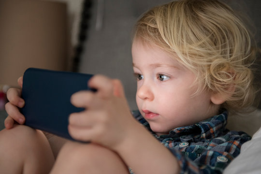 Boy engrossed in video on phone