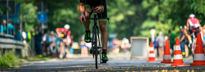 Panorama of a triathlete on a bike - obrazy, fototapety, plakaty