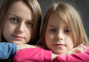 Portrait of a mother and daughter. Photographed close-up.