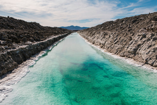 Calcium chloride mine tailings and canal in desert