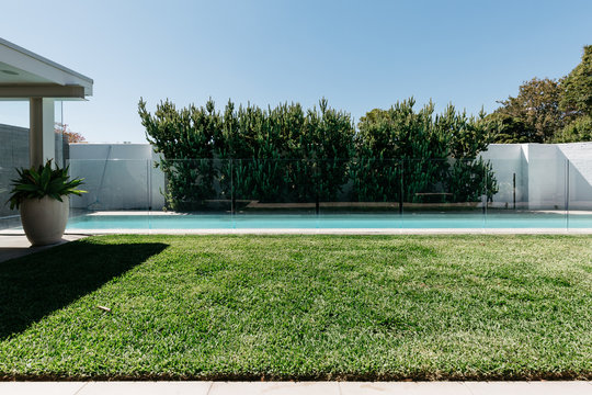 Lineal composition of lap pool and grass in a luxury home