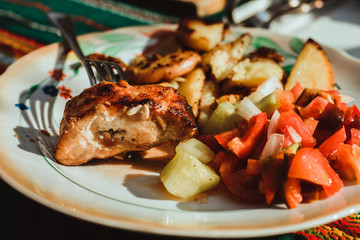 Plate of food: fried potatos, fresh salad and kebab meat