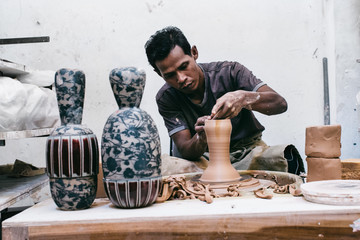 Indonesian Artisan Potter Making Vase on Flywheel in Bright Stud