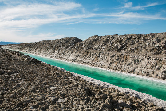 Calcium chloride mine tailings and canal in desert