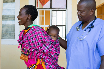 Doctor examining Mother and Baby.