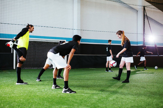 Group of soccer players training in football field.