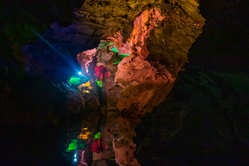Beautiful illuminated multicolored stalactites in Danzhou Stone Flower Caves, Geopark next to Haikou, Hainan, China