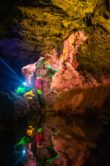 Beautiful illuminated multicolored stalactites in Danzhou Stone Flower Caves, Geopark next to Haikou, Hainan, China