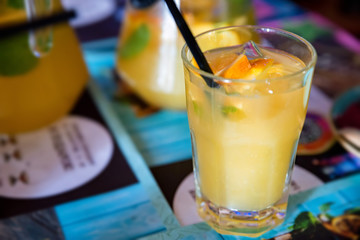 Glass with refreshing cold orange drink close view