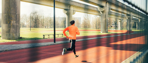 Runner or athlete running on a running track, warming up.