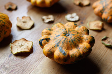 Harvest of yellow squashes with cut dry apples on the table